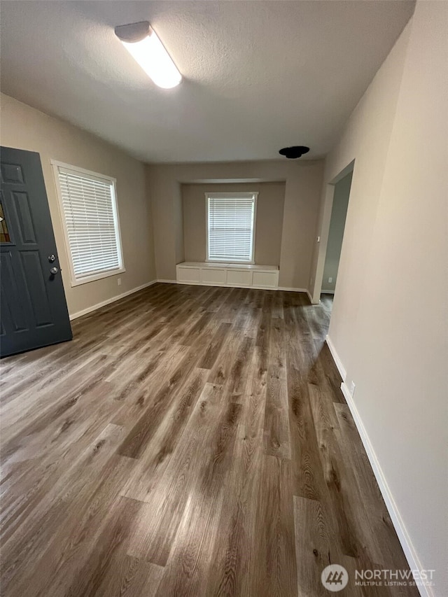 interior space with plenty of natural light, hardwood / wood-style floors, and a textured ceiling