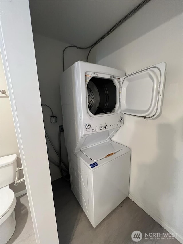 laundry room with stacked washer / dryer