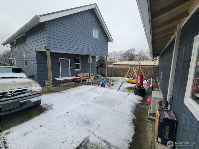 exterior space with a playground and a patio