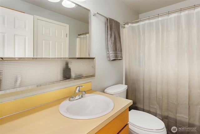 bathroom featuring vanity and toilet