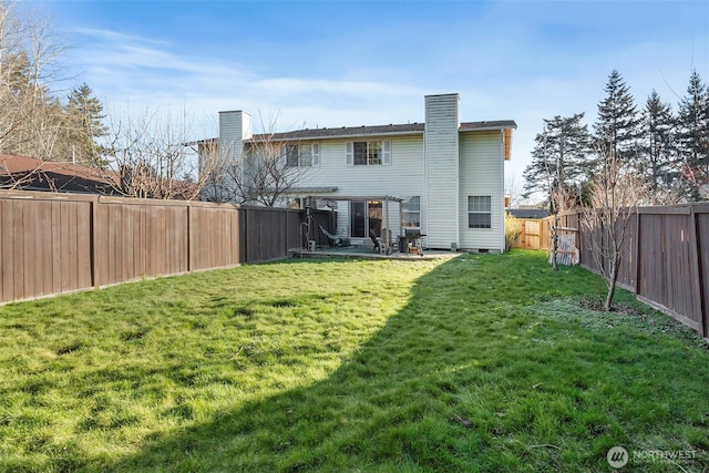 rear view of house with a yard