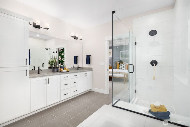 bathroom featuring vanity, tile patterned flooring, and a shower with door