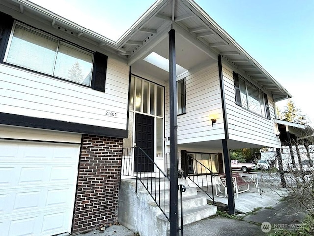 21405 124th Ave SE, Kent, WA 98031 - view of front facade with an attached garage and brick siding