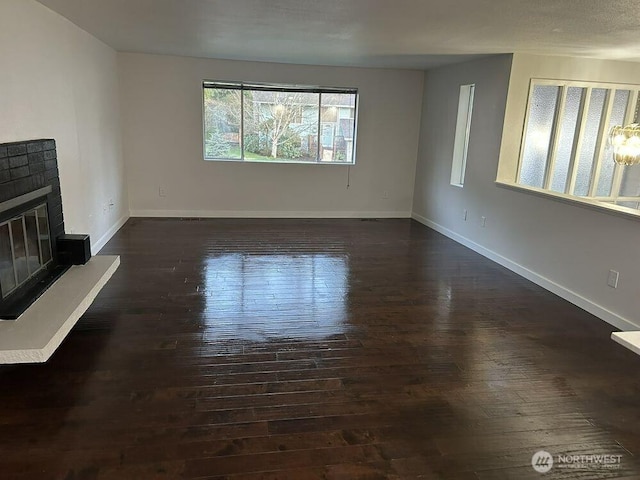 21405 124th Ave SE, Kent, WA 98031 - unfurnished living room with dark wood finished floors, a fireplace, and baseboards