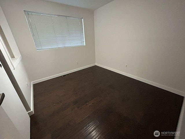 21405 124th Ave SE, Kent, WA 98031 - empty room featuring visible vents, baseboards, and dark wood-style floors