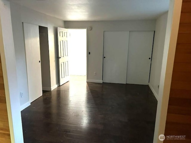 21405 124th Ave SE, Kent, WA 98031 - unfurnished bedroom with baseboards and dark wood-style flooring