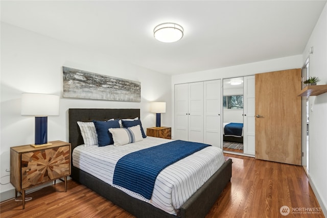 bedroom with a closet and dark hardwood / wood-style floors