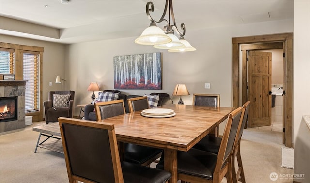carpeted dining space featuring a fireplace