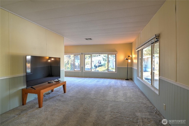 unfurnished living room featuring light colored carpet