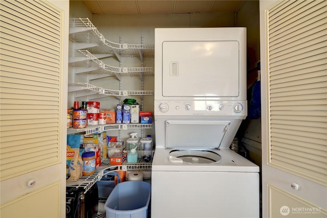 clothes washing area with stacked washer and clothes dryer