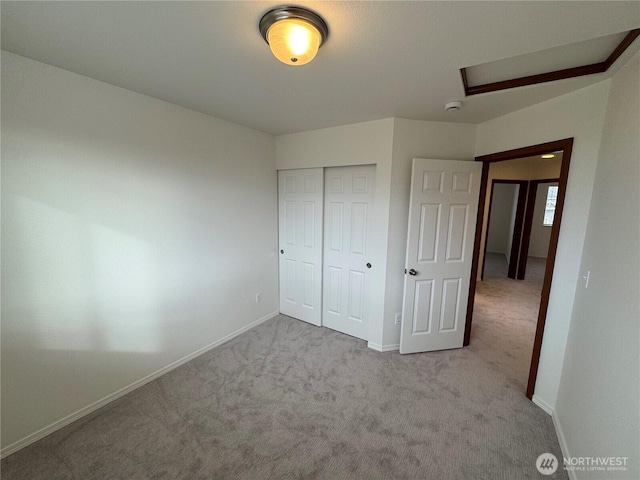 unfurnished bedroom with a closet and light carpet