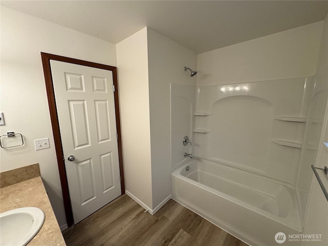 bathroom featuring hardwood / wood-style flooring, vanity, and bathtub / shower combination