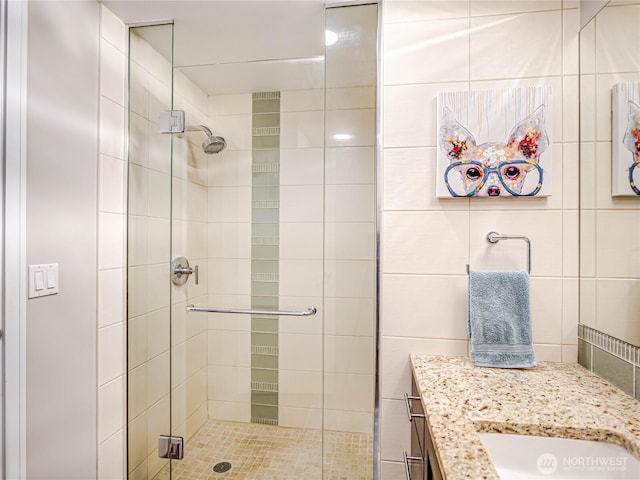 full bath with a shower stall and vanity