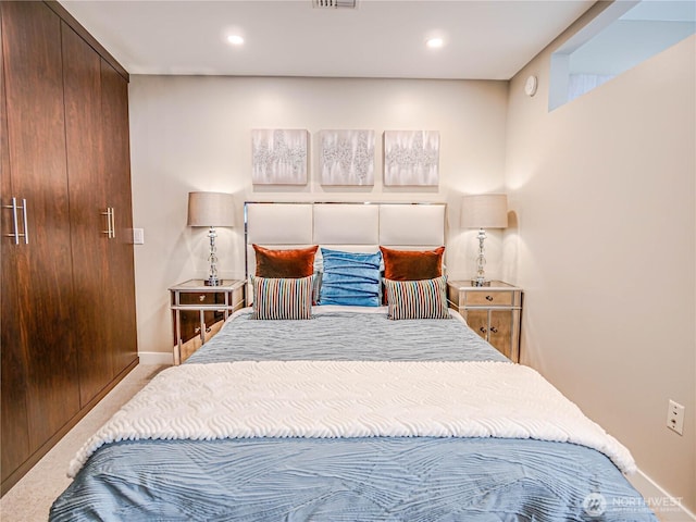 carpeted bedroom featuring baseboards, visible vents, and recessed lighting