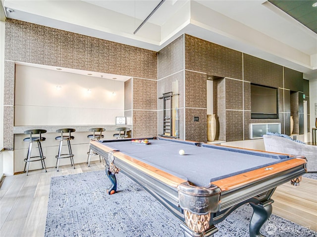 game room featuring billiards, tile walls, and wood finished floors