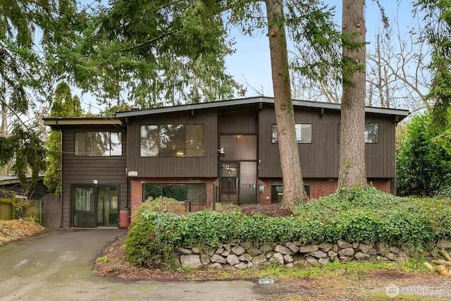 view of front of house with brick siding and aphalt driveway