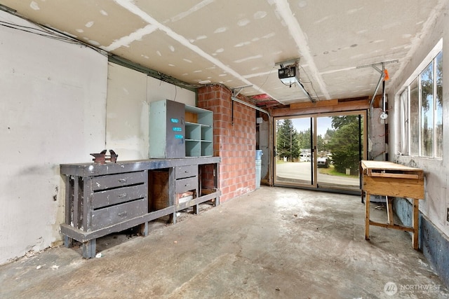 misc room featuring a garage and unfinished concrete flooring