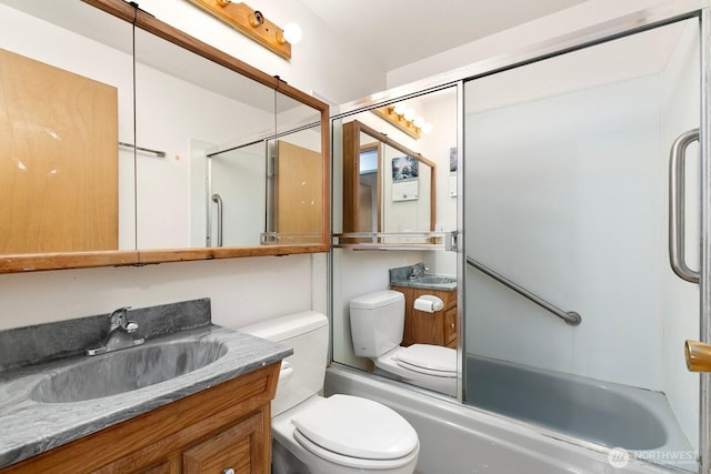 bathroom featuring toilet, vanity, and shower / tub combination