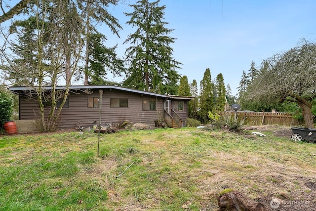 view of yard with entry steps and fence