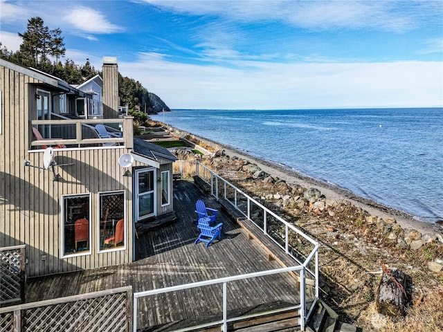 drone / aerial view featuring a water view and a beach view