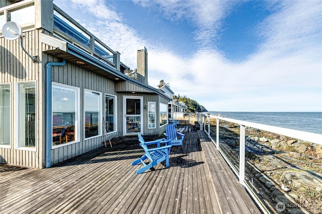 deck featuring a beach view and a water view