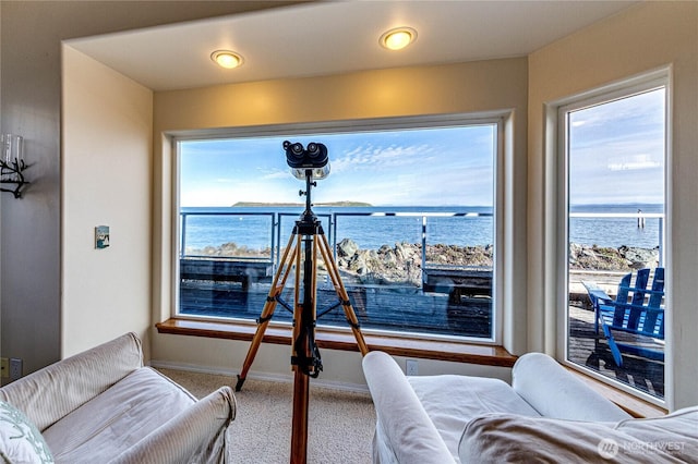 interior space with a water view and baseboards