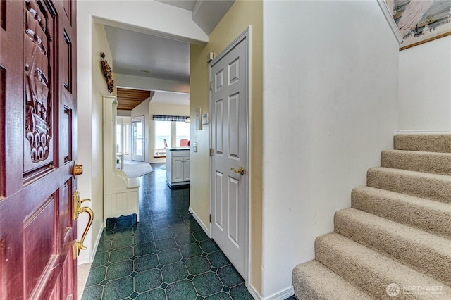 interior space with stairway and baseboards