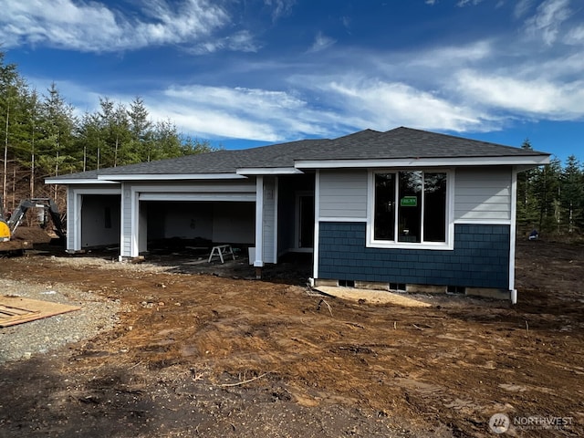 view of front of home with a garage and a shingled roof