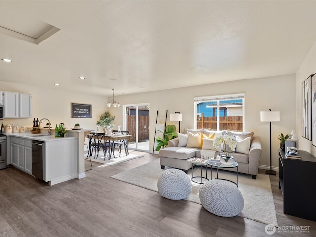 living room featuring recessed lighting, wood finished floors, and baseboards