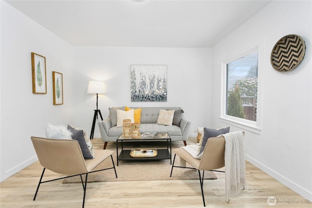 living room featuring light wood-style flooring and baseboards