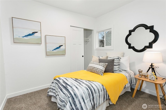 carpeted bedroom with a closet and baseboards