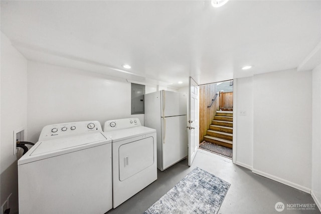 laundry room with washing machine and clothes dryer and electric panel