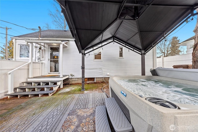 deck with a gazebo and a hot tub