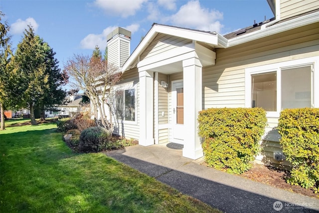 view of side of home with a yard