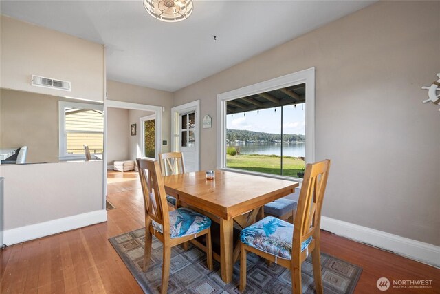 4412 Dyes Inlet Rd NW, Bremerton, WA 98312 - dining area with wood-type flooring, a water view, and plenty of natural light