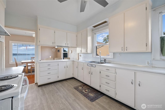 4412 Dyes Inlet Rd NW, Bremerton, WA 98312 - kitchen with sink, ceiling fan, white range with electric cooktop, white cabinetry, and light wood-type flooring