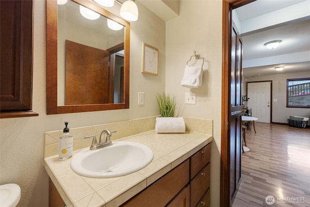 bathroom with hardwood / wood-style flooring and vanity