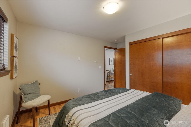 bedroom featuring wood-type flooring and a closet