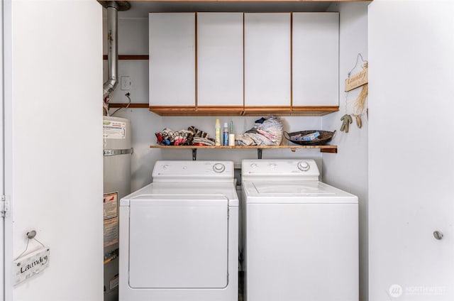 washroom with secured water heater, cabinet space, and independent washer and dryer