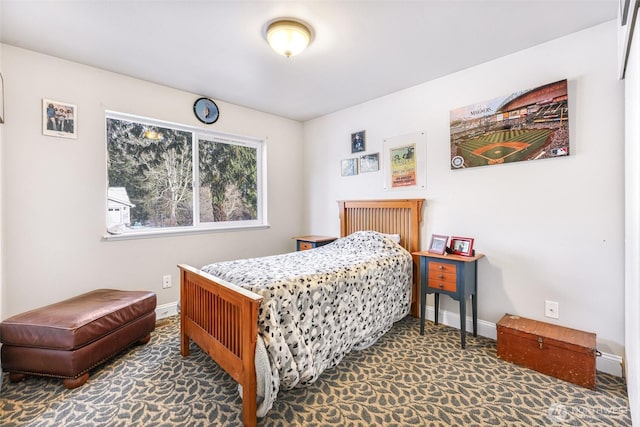 bedroom featuring carpet floors and baseboards