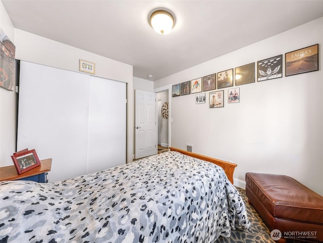 bedroom featuring a closet and baseboards