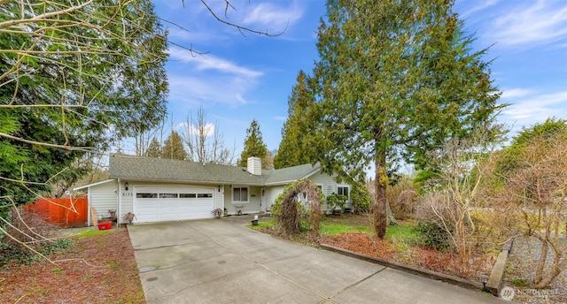 ranch-style house with a garage, driveway, a chimney, and fence