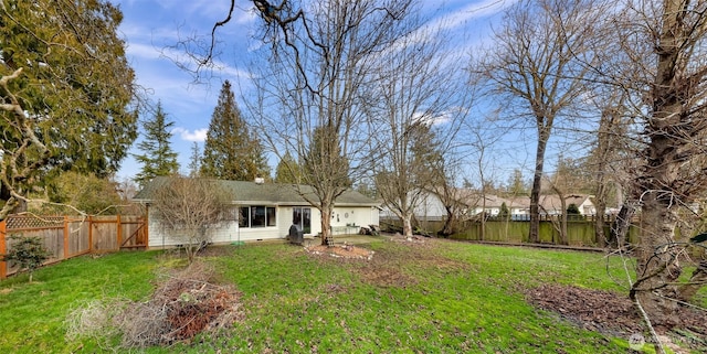 view of yard with a fenced backyard and an attached garage