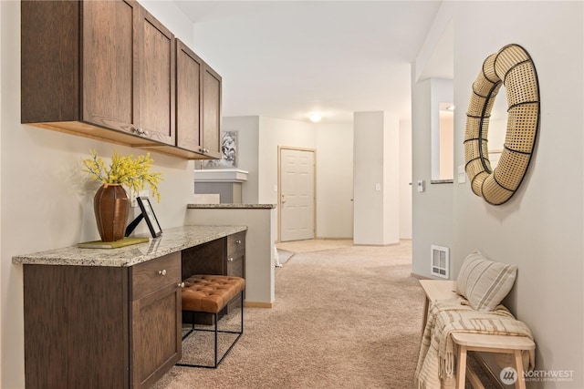 hallway with light colored carpet