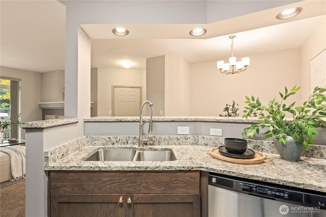 kitchen featuring sink, light stone counters, dark brown cabinets, dishwasher, and pendant lighting