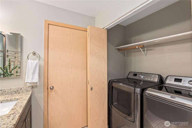 laundry room with separate washer and dryer and sink