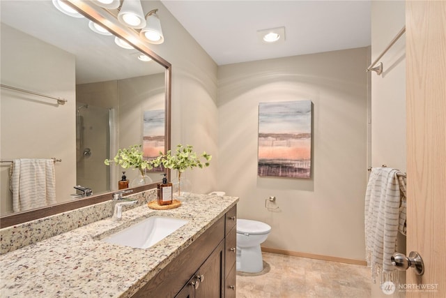 bathroom featuring vanity, toilet, and a shower with shower door