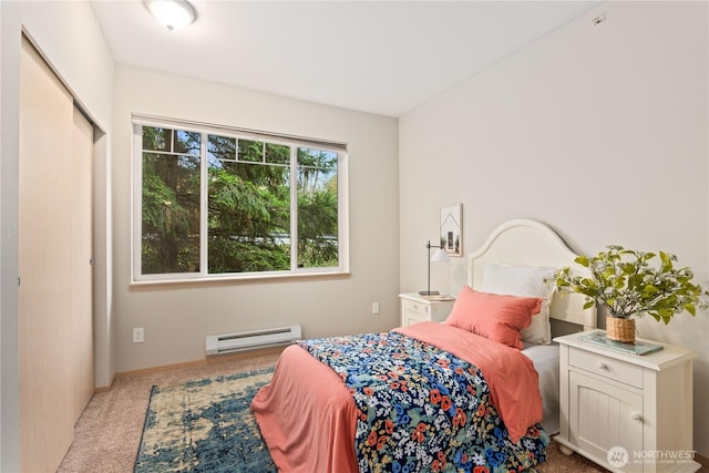 carpeted bedroom with a baseboard heating unit