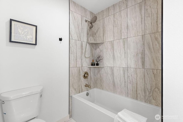 bathroom featuring tiled shower / bath and toilet