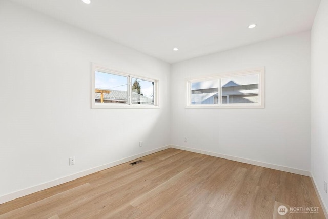 empty room with light hardwood / wood-style flooring